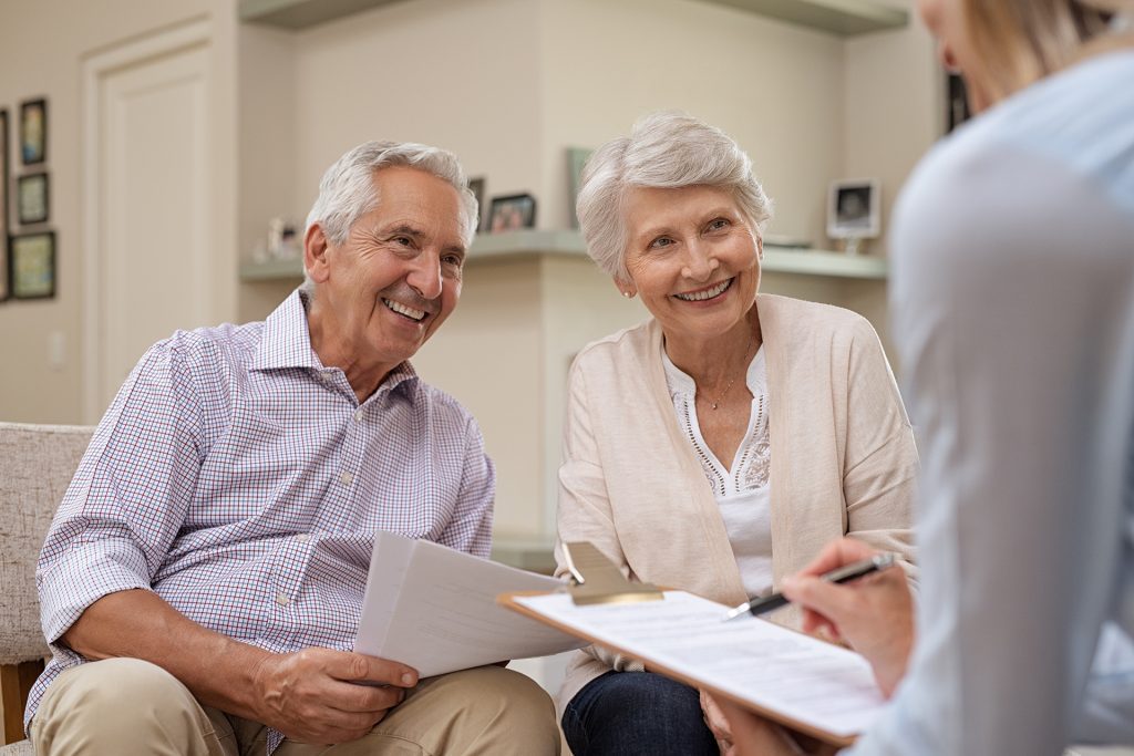 elderly couple discussing estate plans with a legal estate planner